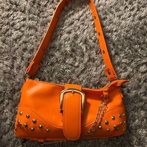 Orange purse with a chain